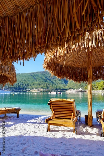 Fototapeta Naklejka Na Ścianę i Meble -  Bodrum, Turkey - August 2020: Hotel beach Lujo. Vacation in Paradise. Beautiful tropical beach banner. White sand travel tourism wide panorama background concept. Amazing beach landscape, yachts