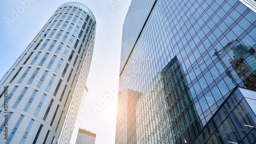 Office building  details of blue glass wall and sun reflections.