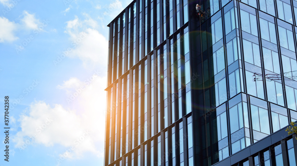 Office building, details of blue glass wall and sun reflections. Office building, details of blue glass wall and sun reflections.