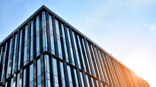 Office building, details of blue glass wall and sun reflections.