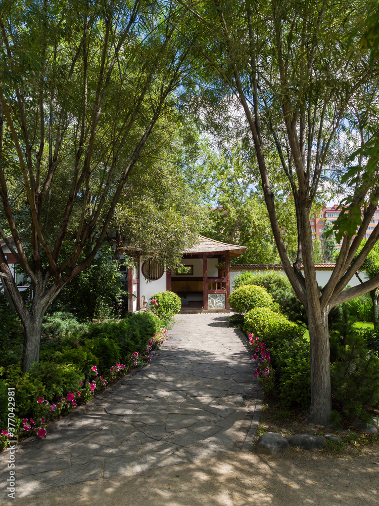 Japanese traditional gazebo in the park. Landscaping. Summer sunny day