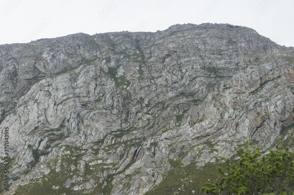 Grey rocky mountain range in natural landscape.