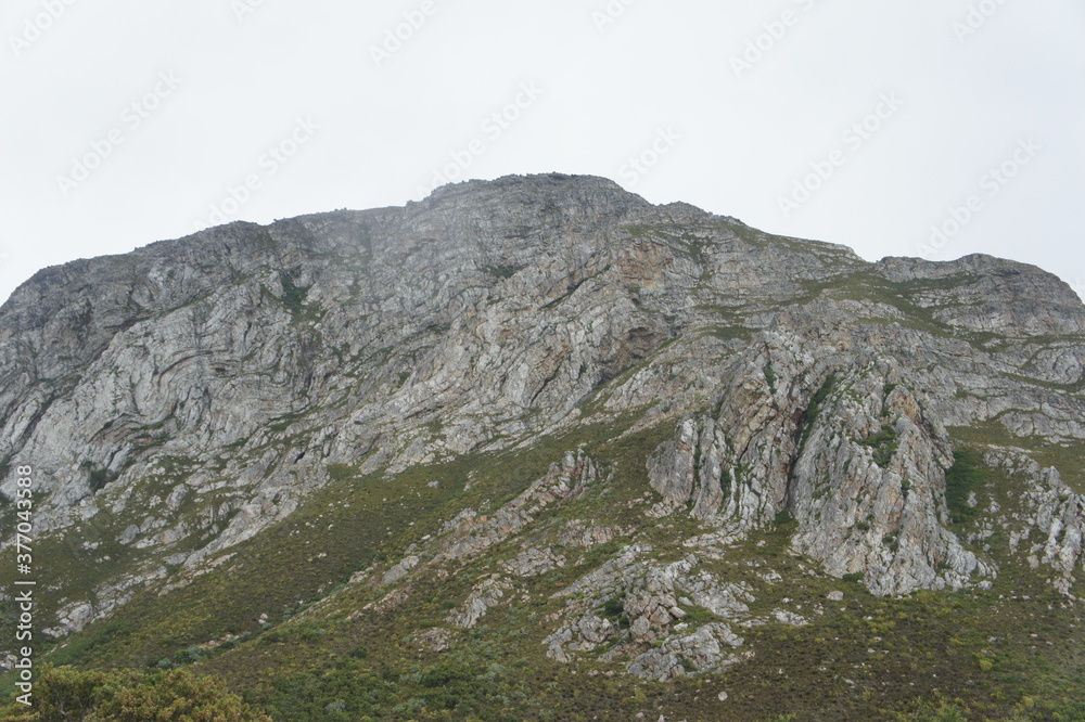 Grey rocky mountain range in natural landscape.
