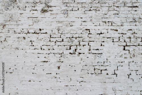 Obraz na płótnie The texture of the old brick wall painted white with peeling paint w salonie