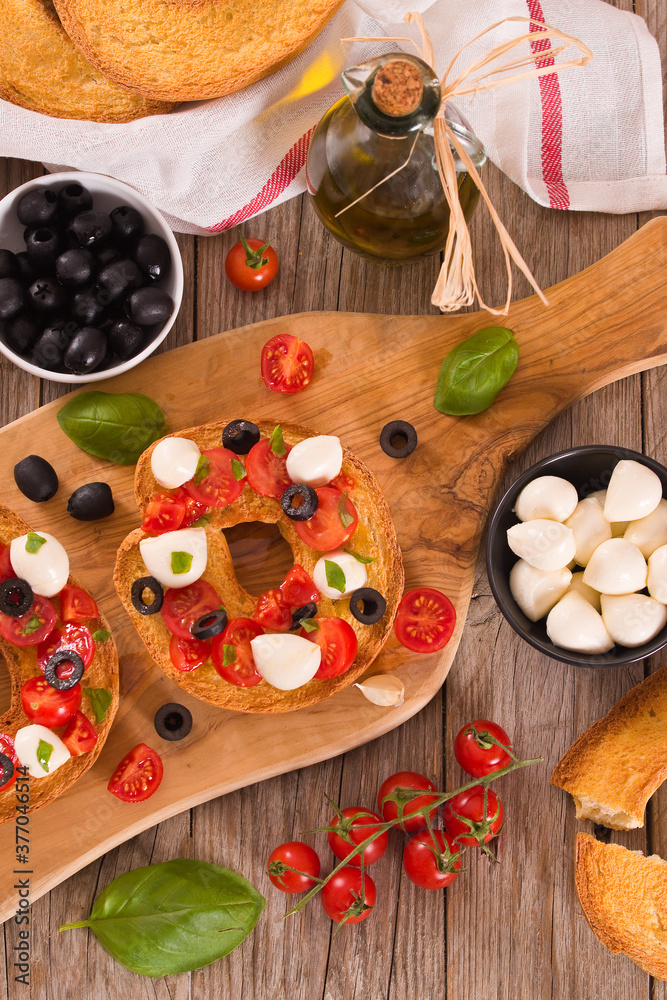 Friselle with tomatoes and mozzarella cheese. Friselle with tomatoes and mozzarella cheese.