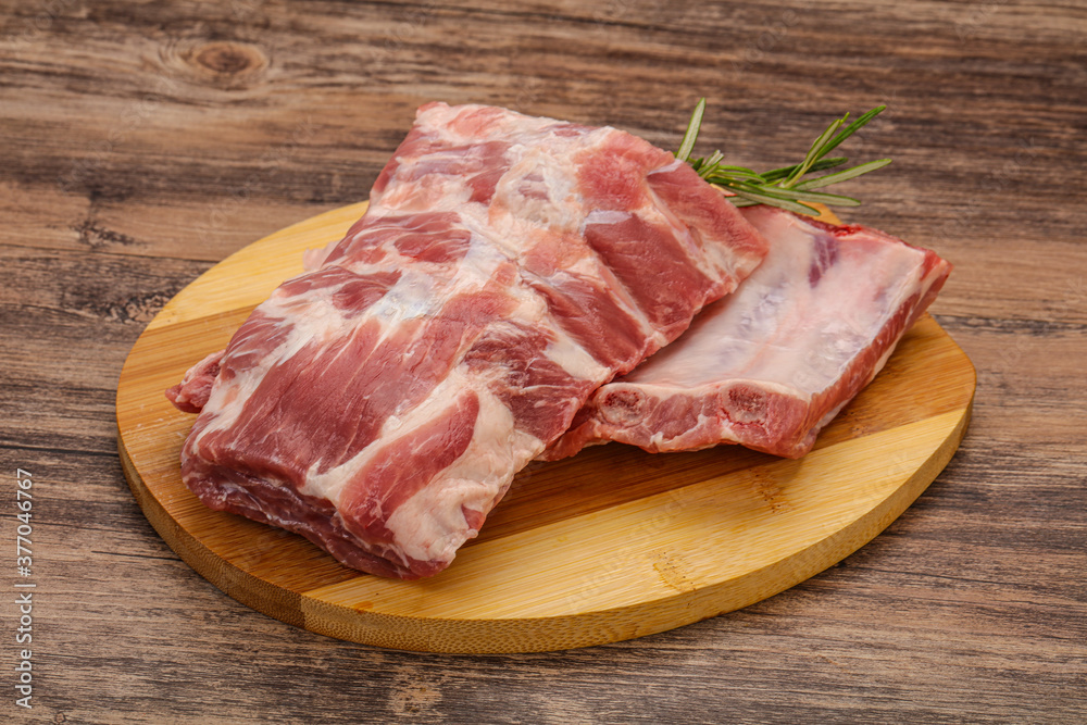 Raw pork ribs served rosemary