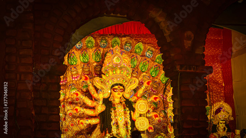 Durga Puja or Durgotsava,is an annual Hindu festival celebrated mainly in West Bengal,India.Durga is Goddess riding a lion with many arms each carrying weapons and defeating evil power of Mahishasura. photo