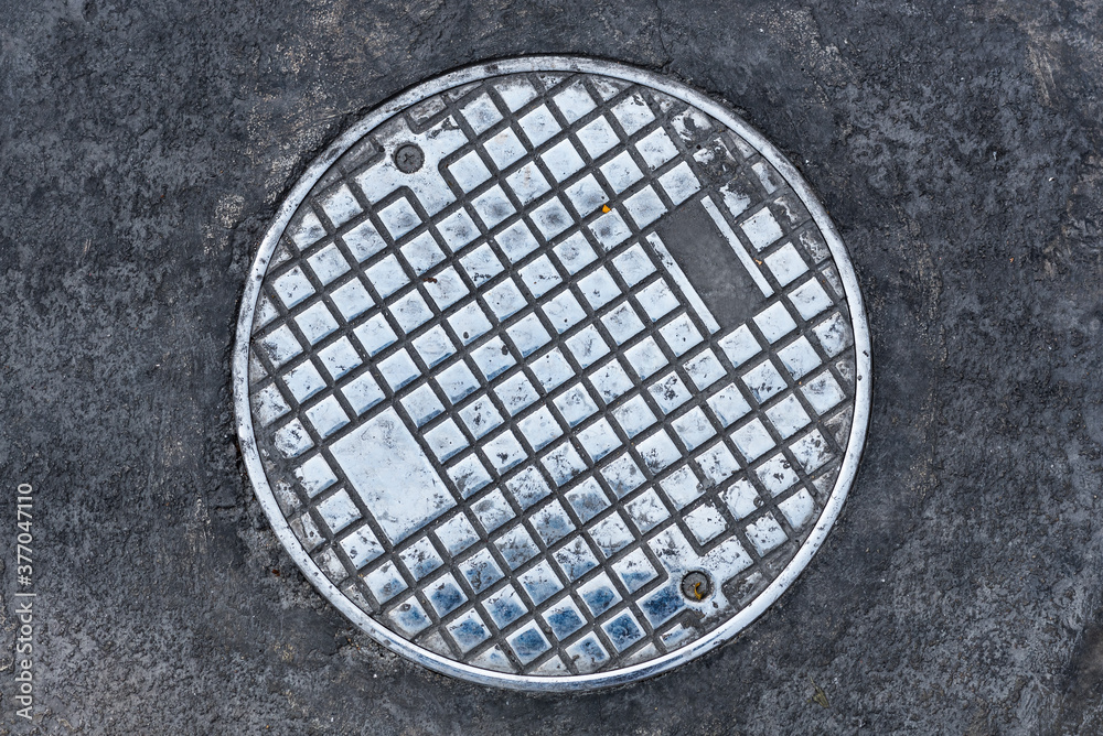 Closeup photo of Old Sewer manhole cover on white background Closeup photo of Old Sewer manhole cover on white background
