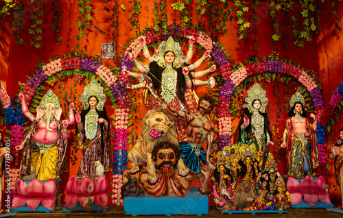 Durga Puja or Durgotsava,is an annual Hindu festival celebrated mainly in West Bengal,India.Durga is Goddess riding a lion with many arms each carrying weapons and defeating evil power of Mahishasura. © Soumen