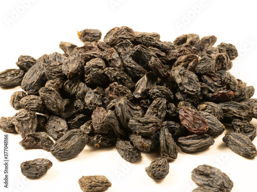 Black raisins on a white background