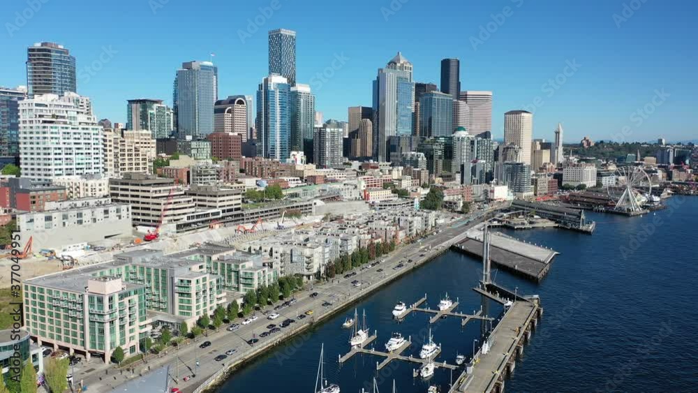 Aerial / drone pan shot of the Seattle waterfront, Belltown, Elliott Bay, Climate Pledge Arena without people downtown, in the commercial district of Seattle, Washington during the pandemic Aerial / drone pan shot of the Seattle waterfront, Belltown, Elliott Bay, Climate Pledge Arena without people downtown, in the commercial district of Seattle, Washington during the pandemic