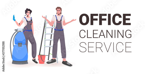 professional office cleaners man woman janitors in uniform with cleaning equipment standing together full length copy space horizontal vector illustration
