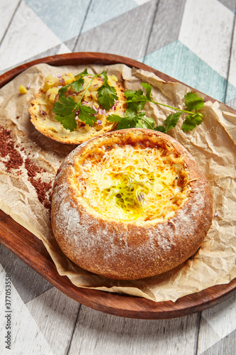 Cheese soup served in round bread loaf