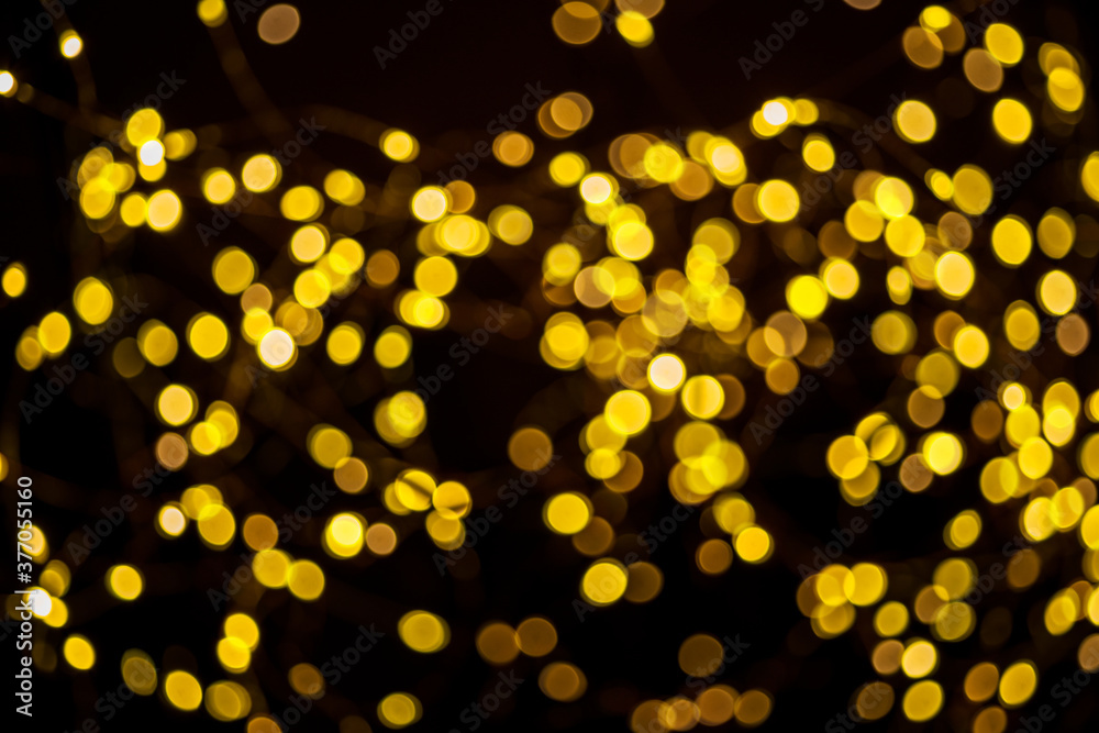 Blurred christmas lights on on dark background as a symbol of Christmas or New Year mystery and magic. Christmas background. Blurred christmas lights on on dark background as a symbol of Christmas or New Year mystery and magic. Christmas background.