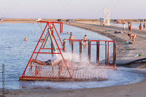 Genicheskaya Gorka, Kherson region, Ukraine August 19 2020: a man takes a hydromassage on a salt lake photo