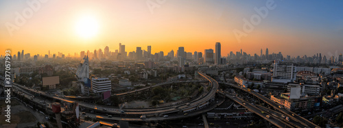 Panorama view of modern office buildings, condominium and skyscraper tower in big city downtown with sunset sky © ChomchoeiFoto