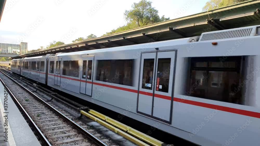 open-air metro station in vienna with train arrival