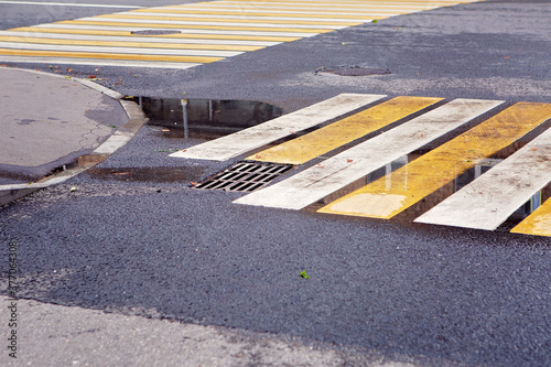 White and yellow pedestrian crossing in a puddle