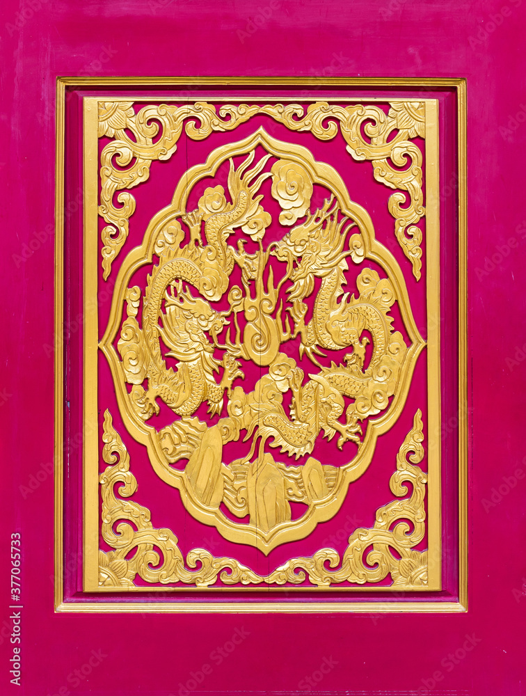 Golden dragon carved decorated on red wooden door, Chinese style in Chinese temple,Thailand. The public domain or treasure of Buddhism, no restrict in copy or use