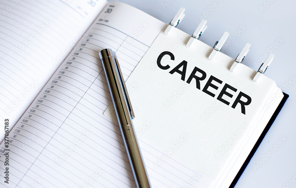 text CAREER on the short note texture background with pen text CAREER on the short note texture background with pen