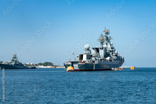 Large gray warship in the seaport.