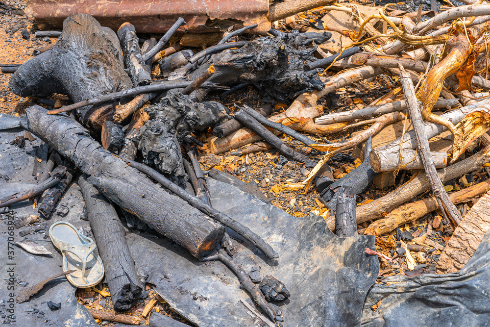 Branches that are burned to make natural charcoal for sale.