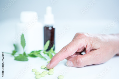 Patient taking pills. Herbal medicine.
