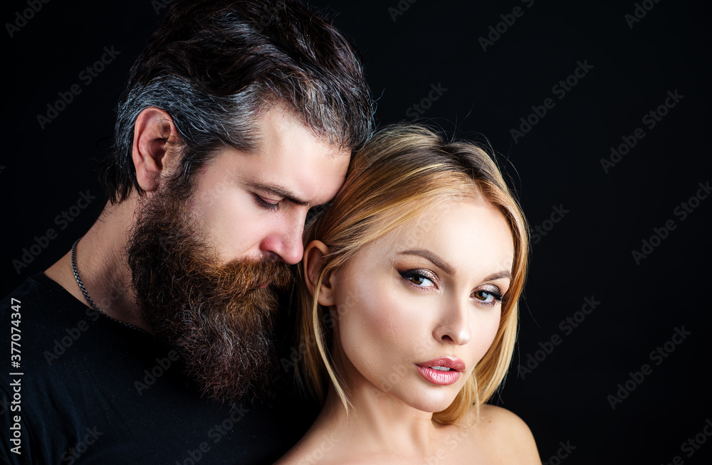 Fashion vogue stylish young couple looking at camera in studio on black. Hipsters love. Rock style.