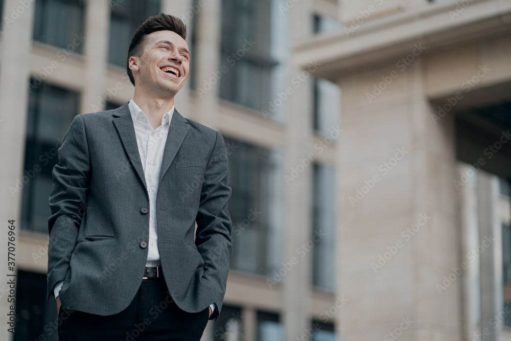 male businessman smiling enjoying life, background business center male businessman smiling enjoying life, background business center