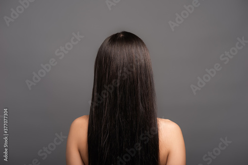 back view of naked brunette long haired woman isolated on black