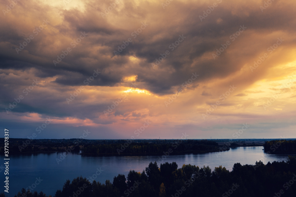Evening landscape over the river, sky with clouds, sunset Evening landscape over the river, sky with clouds, sunset