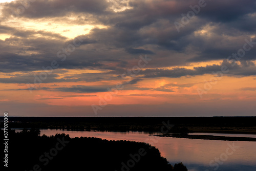 Evening landscape over the river, sky with clouds, sunset