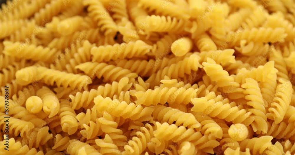 Heap of rotating fusilli pasta on plate closeup Heap of rotating fusilli pasta on plate closeup
