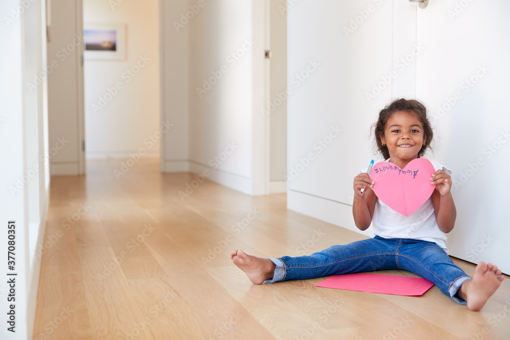 Portrait Of Hispanic Girl Sitting On Floor Making Card For Mothers Day Portrait Of Hispanic Girl Sitting On Floor Making Card For Mothers Day