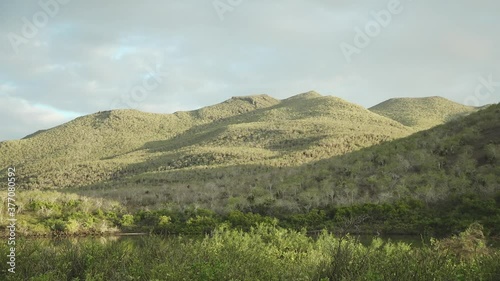 Lush Green Mountains and Lake at Sunset on Rabida Island, Galapagos