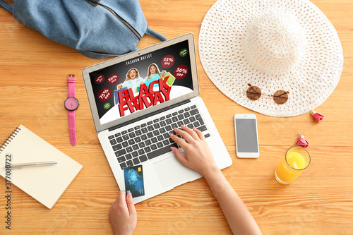 Young woman using laptop fo...