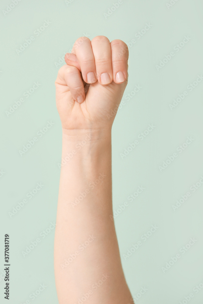 Hand showing letter M on color background. Sign language alphabet Hand showing letter M on color background. Sign language alphabet