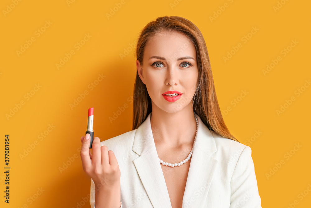 Obraz premium Beautiful young woman with lipstick on color background