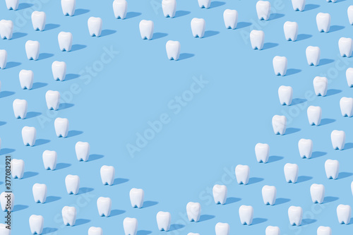 White teeth pattern on a blue paper background with text place.