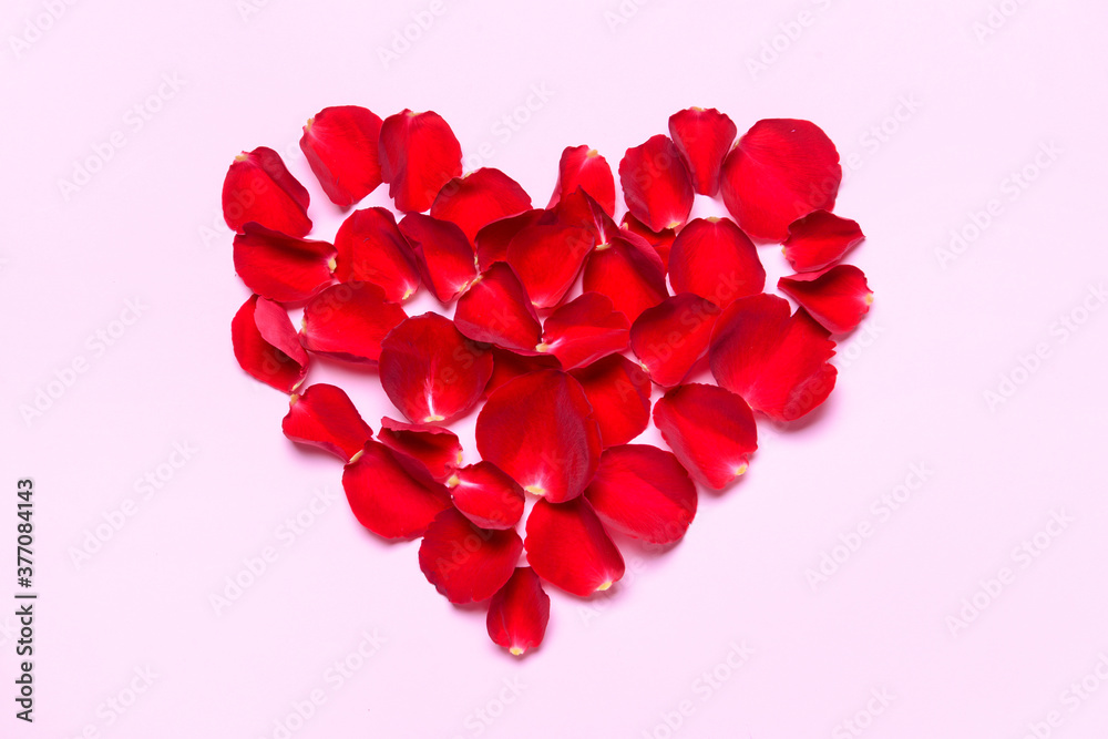 Heart made of beautiful rose petals on color background Heart made of beautiful rose petals on color background