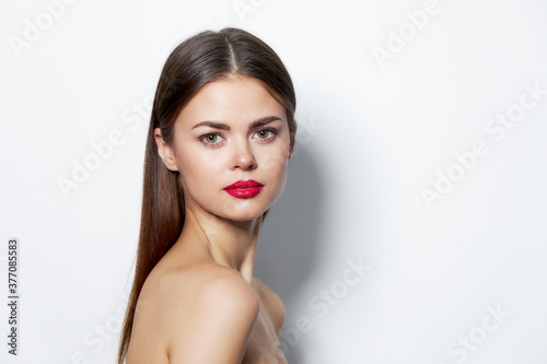 Woman portrait looking forward red lips bare shoulders skin care 