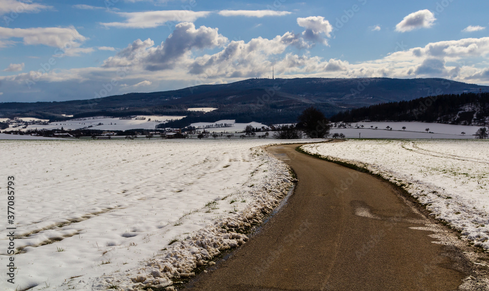 Hill Klet in winter. Czech landscape with road and snow field