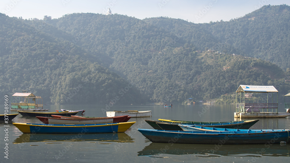 View over a few colorful boats on Phewa Lake, Pokhara