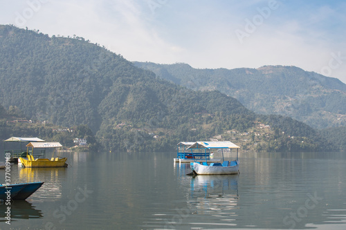 View over a few colorful boats on Phewa Lake, Pokhara