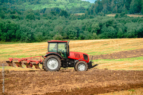 Agricultural tractor plowing the field
