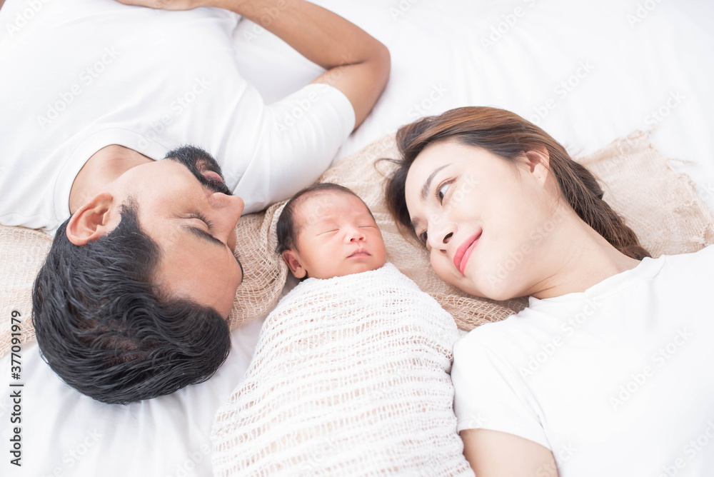 smiling mother and father holding their newborn baby at home..portrait of happy family at home, young parents holding on hands little sweet newborn baby, love and happiness concept. smiling mother and father holding their newborn baby at home..portrait of happy family at home, young parents holding on hands little sweet newborn baby, love and happiness concept.