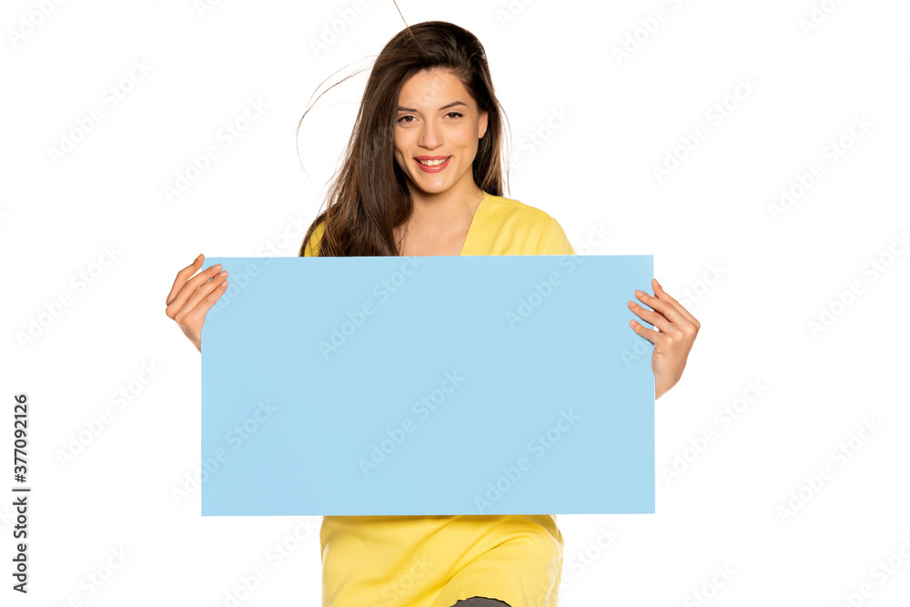 young beautiful happy woman holding a blue empty board young beautiful happy woman holding a blue empty board