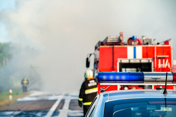 police control a fire on the road