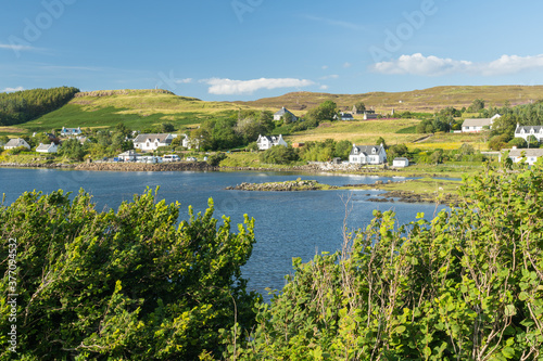 Scenic view of Dunvegan village, Isle of Skye, on beautiful sunny summer day. Typical Scottish countryside in Highlands by a sea loch