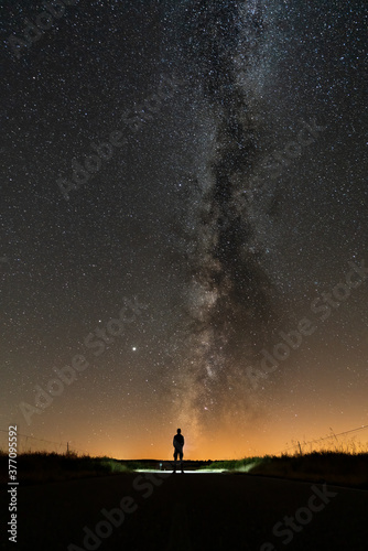 Rear view of 1 person silhouette at night with milky way